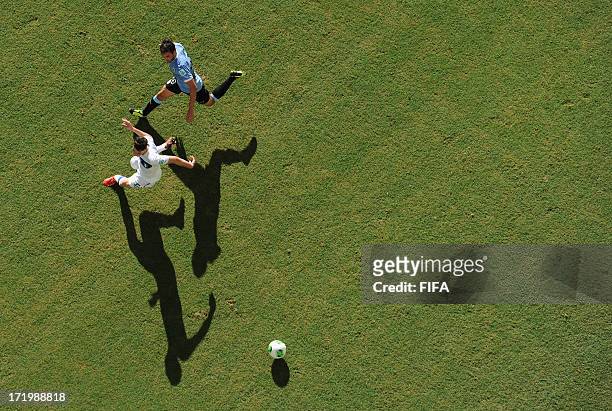 In this handout image provided by FIFA Alvaro Gonzalez of Uruguay competes with Mattia De Sciglio of Italy during the FIFA Confederations Cup Brazil...
