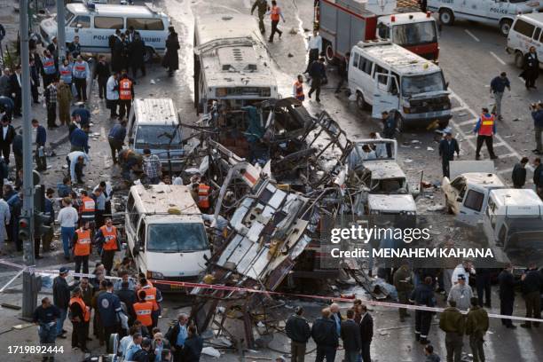 Rescue teams search for victims in the wreckage of a bus that exploded in Jerusalem on February 25, 1996. At least 23 Israelis were killed and more...