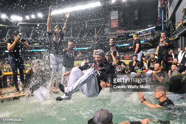 October 11: The Arizona Diamondback dive into a pool to celebrate defeating the Los Angeles Dodgers in three games in the National League Division...
