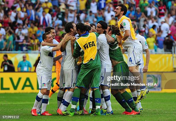 Gianluigi Buffon of Italy celebrates with his team-mates after saving the penalty of Walter Gargano of Uruguay to clinch victory in a shootout during...