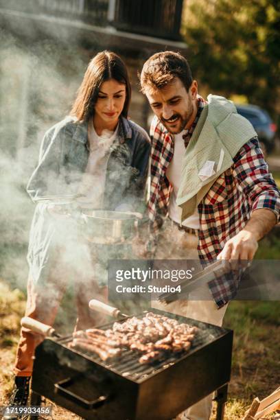 meat ready to take off from a bbq - couple grilling stock pictures, royalty-free photos & images