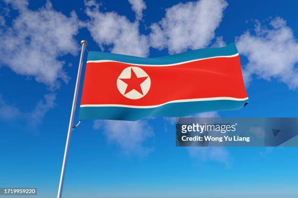 dprk ( democratic people's republic of korea ) north korea's flag with blue sky background - north korea stockfoto's en -beelden