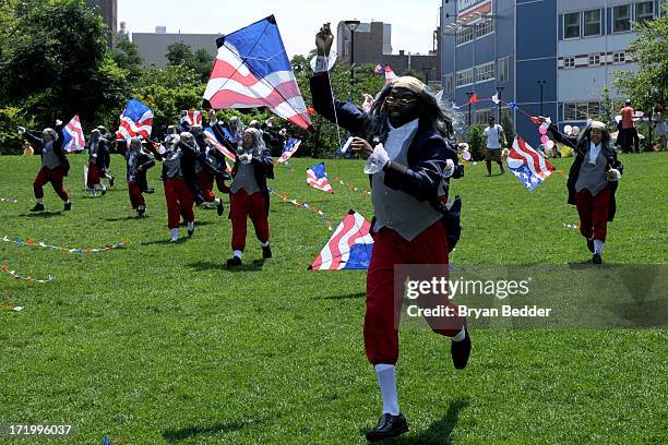 Actors dressed as Benjamin Franklin fly kites on June 29, 2013 in New York City. In honor of July 4th, Virgin Mobile enlisted 100 Benjamin Franklins...