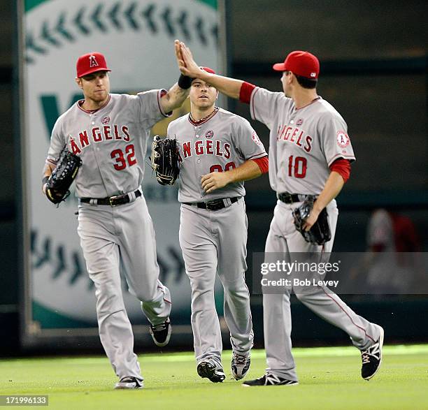 Josh Hamilton high-fives Brad Hawpe and J.B. Shuck of the Los Angeles Angels of Anaheim after the final out as they defeat the Houston Astros 3-1 at...