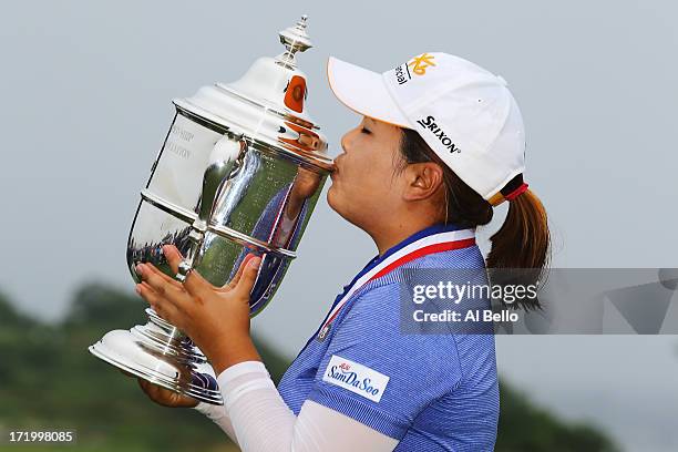 Inbee Park of South Korea holds the first place trophy after winning the 2013 U.S. Women's Open at Sebonack Golf Club on June 30, 2013 in...