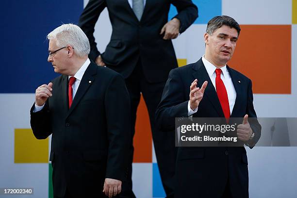 Ivo Josipovic, Croatia's president, left, and Zoran Milanovic, Croatia's prime minister, react as they wait for fellow dignitaries to arrive for a...