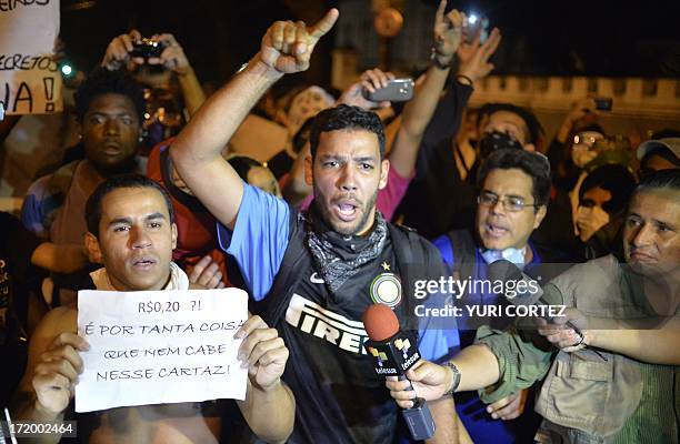 Protestors chant slogans during a demonstration on a street near Maracana stadium in Rio de Janeiro, Brazil on June 30 a few hours before the final...