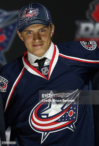 Alexander Wennberg poses with his jersey after being selected number fourteen overall in the first round by the Columbus Blue Jackets during the 2013...