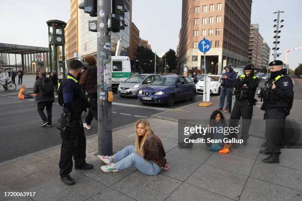 Police detain climate activists including Anja Windl from the group "Last Generation" who sought to glue themselves to the asphalt at Potsdamer Platz...