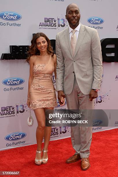 Former basketball player, actor and talk show host John Salley and his wife Natasha arrive for the 2013 BET Awards at the Nokia Theatre L.A. Live in...