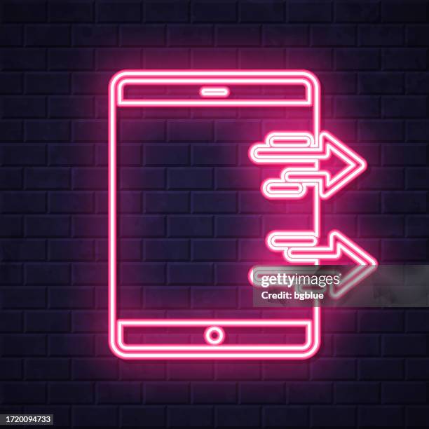 send from tablet pc. glowing neon icon on brick wall background - touch screen wall stock illustrations