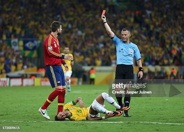 Gerard Pique of Spain is shown a red card by Referee Bjorn Kuipers for a tackle on Neymar of Brazil during the FIFA Confederations Cup Brazil 2013...