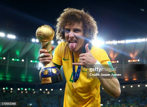 David Luiz of Brazil poses with the trophy at the end of the FIFA Confederations Cup Brazil 2013 Final match between Brazil and Spain at Maracana on...