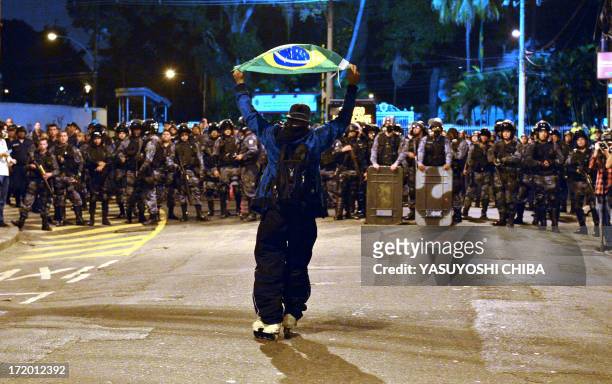 Protestors clash with riot squad officers on a street near Maracana stadium in Rio de Janeiro, Brazil on June 30 a few hours before the final of the...