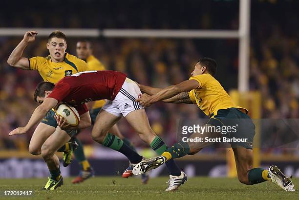 James O'Connor of the Wallabies tackles Jonathon Sexton of the Lions during game two of the International Test Series between the Australian...