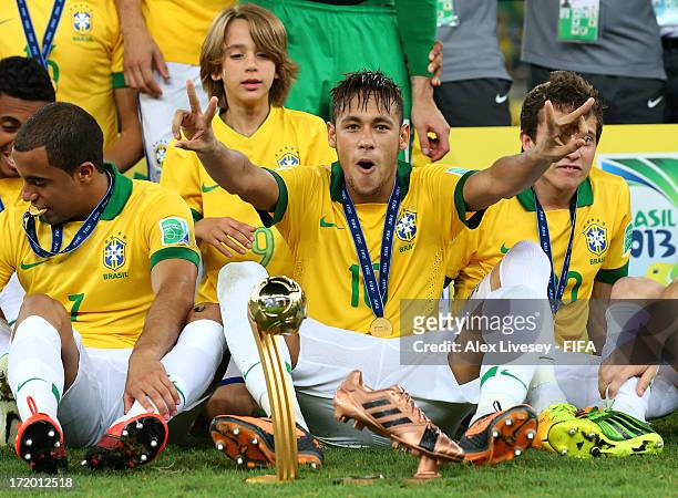 Neymar of Brazil celebrates with his adidas Golden Ball and Bronze boot awards at the end of the FIFA Confederations Cup Brazil 2013 Final match...