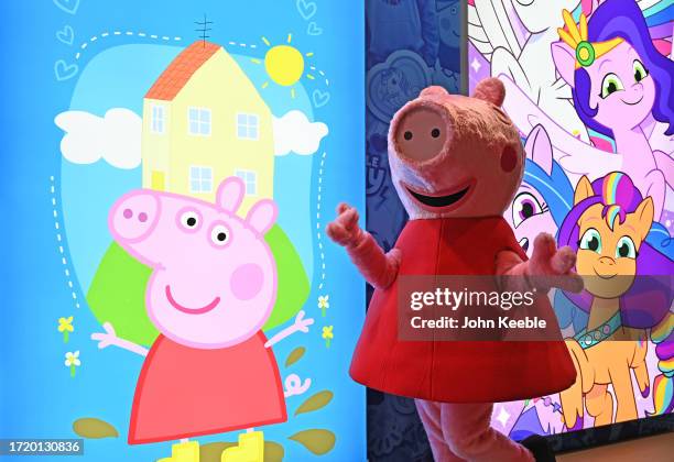 Peppa Pig character poses next to a poster at the Hasbro stand during the Brand Licensing Europe at ExCel on October 04, 2023 in London, England....