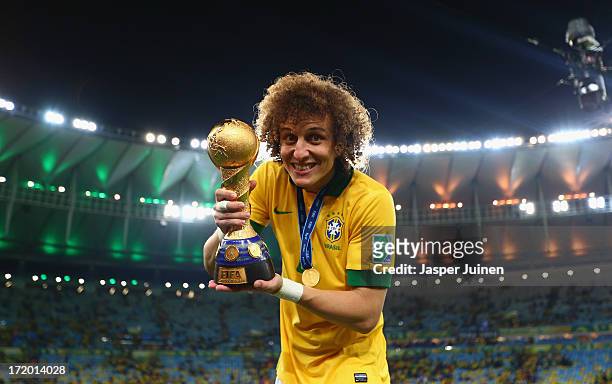David Luiz of Brazil poses with the trophy at the end of the FIFA Confederations Cup Brazil 2013 Final match between Brazil and Spain at Maracana on...