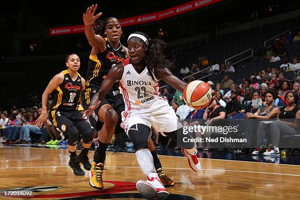 Matee Ajavon of the Washington Mystics drives against Glory Johnson of the Tulsa Shock at the Verizon Center on June 30, 2013 in Washington, DC. NOTE...