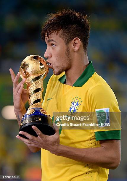 Neymar of Brazil kisses the trophy at the end of the FIFA Confederations Cup Brazil 2013 Final match between Brazil and Spain at Maracana on June 30,...