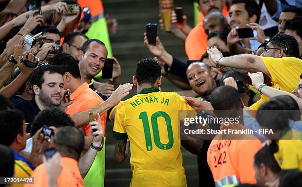 Neymar of Brazil is congratulated by fans at the end of the FIFA Confederations Cup Brazil 2013 Final match between Brazil and Spain at Maracana on...