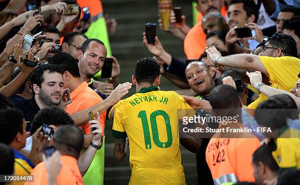 Neymar of Brazil is congratulated by fans at the end of the FIFA Confederations Cup Brazil 2013 Final match between Brazil and Spain at Maracana on...