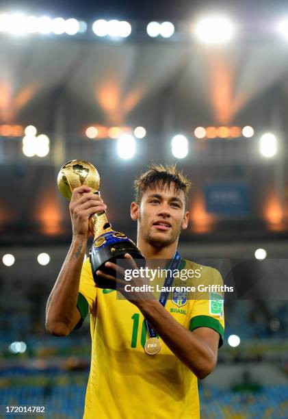 Neymar of Brazil poses with the trophy at the end of the FIFA Confederations Cup Brazil 2013 Final match between Brazil and Spain at Maracana on June...