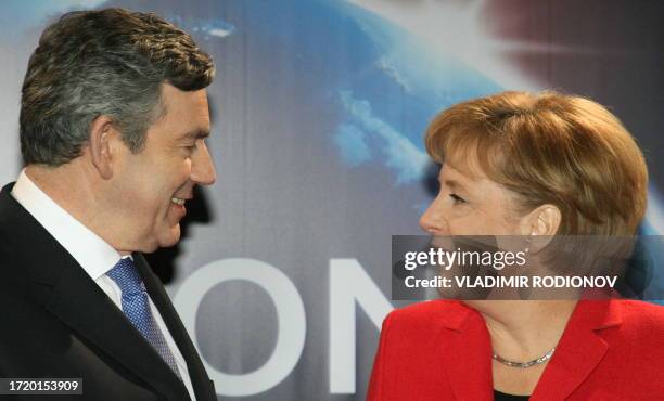 Britain's Prime Minister Gordon Brown speaks with German Chancellor Angela Merkel on her arrival in London on April 2, 2009 during the G-20 summit....