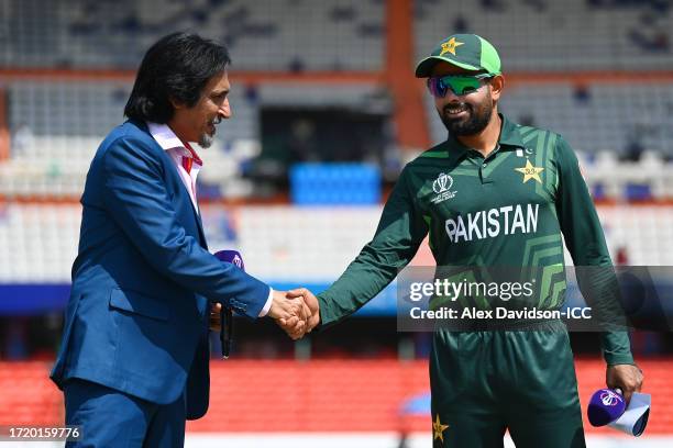 Babar Azam of Pakistan shakes hands with commentator Ramiz Raja following the coin toss prior to the ICC Men's Cricket World Cup India 2023 between...