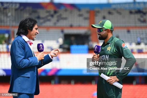 Babar Azam of Pakistan speaks with commentator Ramiz Raja following the coin toss prior to the ICC Men's Cricket World Cup India 2023 between...