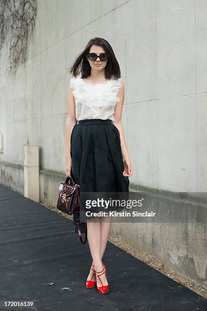 Fashion Blogger Doina Ciobanu wears Christian Louboutin shoes, Rhea Costa skirt and top, Louis Vuitton bag and Dior sunglasses on day 4 of Paris...