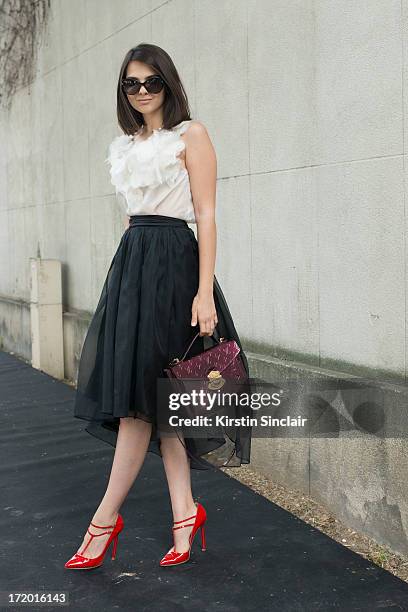 Fashion Blogger Doina Ciobanu wears Christian Louboutin shoes, Rhea Costa skirt and top, Louis Vuitton bag and Dior sunglasses on day 4 of Paris...