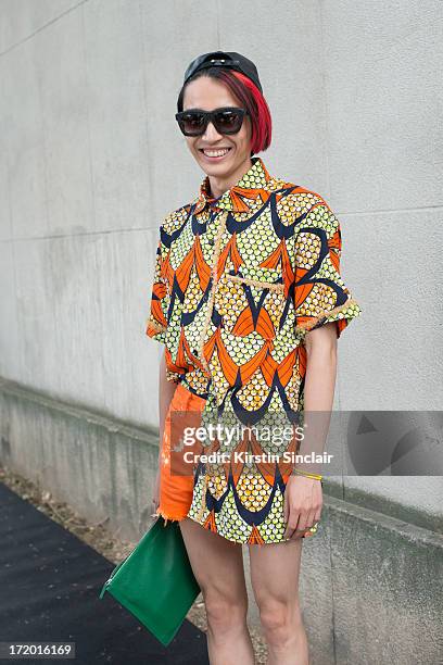 Chief fashion editor of Men's Health China Boynam wears a Marc Jacobs hat, Koops sunglasses, Vintage Kenzo shirt, Levi's shorts, Givenchy clutch on...