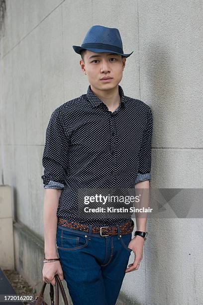 Yong Hao Yu wears Zara jeans and hat, Tom Lee shirt on day 4 of Paris Collections: Men on June 29, 2013 in Paris, France.