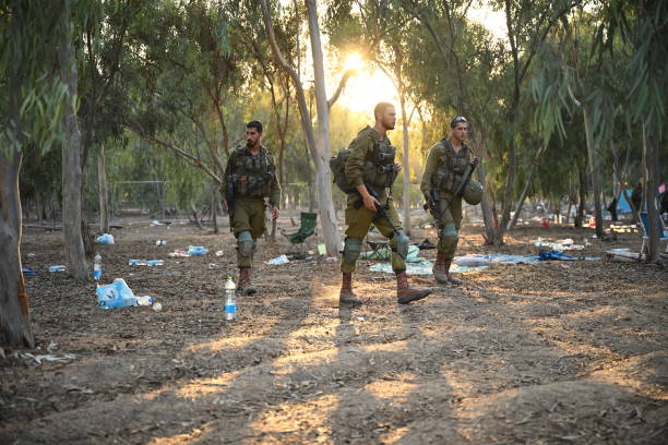 Israeli soldiers continue to search cars and tents for identification and personal belongings at the site of the Supernova Music Festival where hundreds of people were killed...