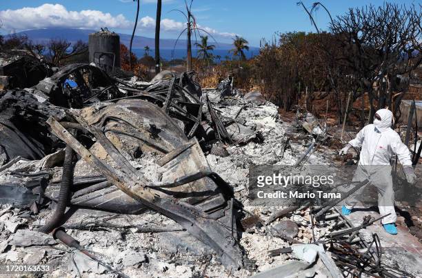 Displaced resident William Anthony walks while searching for personal items at the wildfire destroyed home where he lived on October 05, 2023 in...