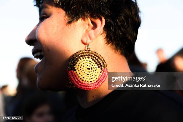 Concertgoer wearing an Aboriginal flag earring at 'Now & Forever' at Shepparton Showgrounds on October 06, 2023 in Shepparton, Australia. An Artist...