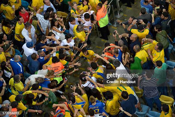 In this handout image provided by FIFA Neymar of Brazil is congratulated by fans at the end of the FIFA Confederations Cup Brazil 2013 Final match...