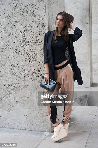 Model Emiley Ratajkowski wears Chloe trousers, Rick Owens vest, Wendy Nicholls jacket, M.A Cross bag and Etscallatay shoes on day 3 of Paris...