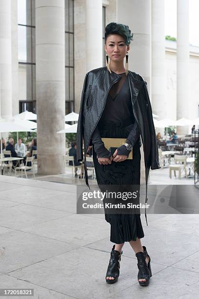 Group Fashion Director of The Rake Esther Quek wears Michael Kors shoes with a Harry Halim dress and jacket on day 3 of Paris Collections: Men on...