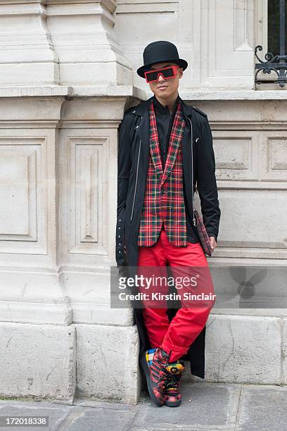 And Fashion blogger Peter Xu wears Adidas trainers, 5cm trousers, a Comme des Garcons jacket, Rad Hourani with Mikita sunglasses, Givenchy clutch bag...