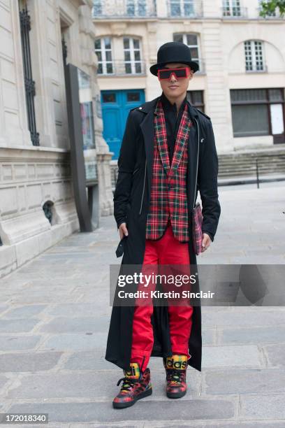 And Fashion blogger Peter Xu wears Adidas trainers, 5cm trousers, a Comme des Garcons jacket and tops, Rad Hourani with Mikita sunglasses, Givenchy...