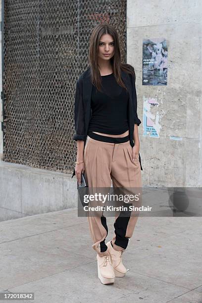 Model Emiley Ratajkowski wears Chloe trousers, Rick Owens vest, Wendy Nicholls jacket, M.A Cross bag and Etscallatay shoes on day 3 of Paris...