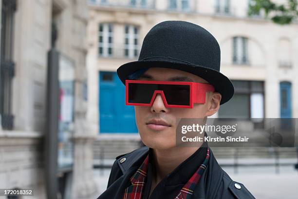 And Fashion blogger Peter a Comme des Garcons jacket and tops, Rad Hourani with Mikita sunglasses and a Henry Vibskov hat on day 3 of Paris...