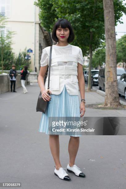 Fashion Ediotor for mens Elle Magazine China Yoyo Lu wears Prada shoes, Comme Des Garcons top, Marni Bag, Cos skirt and t-shirt on day 3 of Paris...