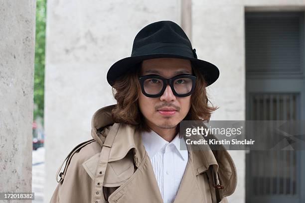 Dgnak merchandising manager Kiryong Han wears a Juun J jacket, Dgnak shirt, Christy's hat and Kuboraum glasses on day 3 of Paris Collections: Men on...
