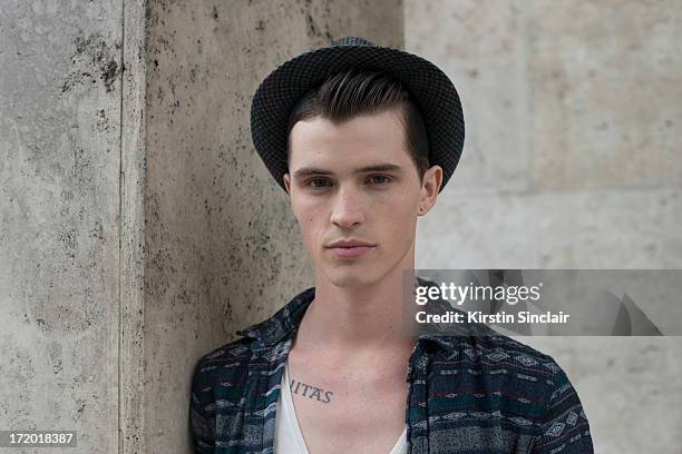 Model Taylor Cowan wears a vintage hat, H and M t-shirt, Topman shirt on day 3 of Paris Collections: Men on June 28, 2013 in Paris, France.