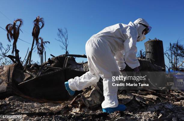 Displaced resident Caroline Anthony searches for personal items in the rubble of the wildfire destroyed home where she lived on October 05, 2023 in...