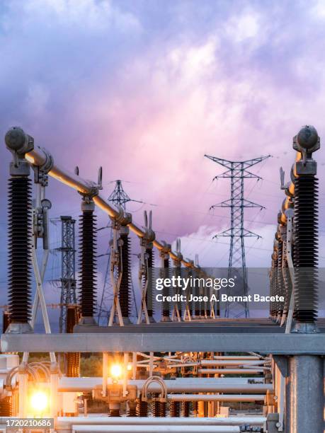 general view of a power distribution power plant at sunset. - electricity substation stock pictures, royalty-free photos & images