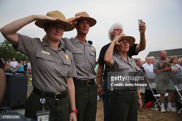 National Park Service rangers salute during the National Anthem on June 30, 2013 in Gettysburg, Pennsylvania. Hundreds of people gathered for the...
